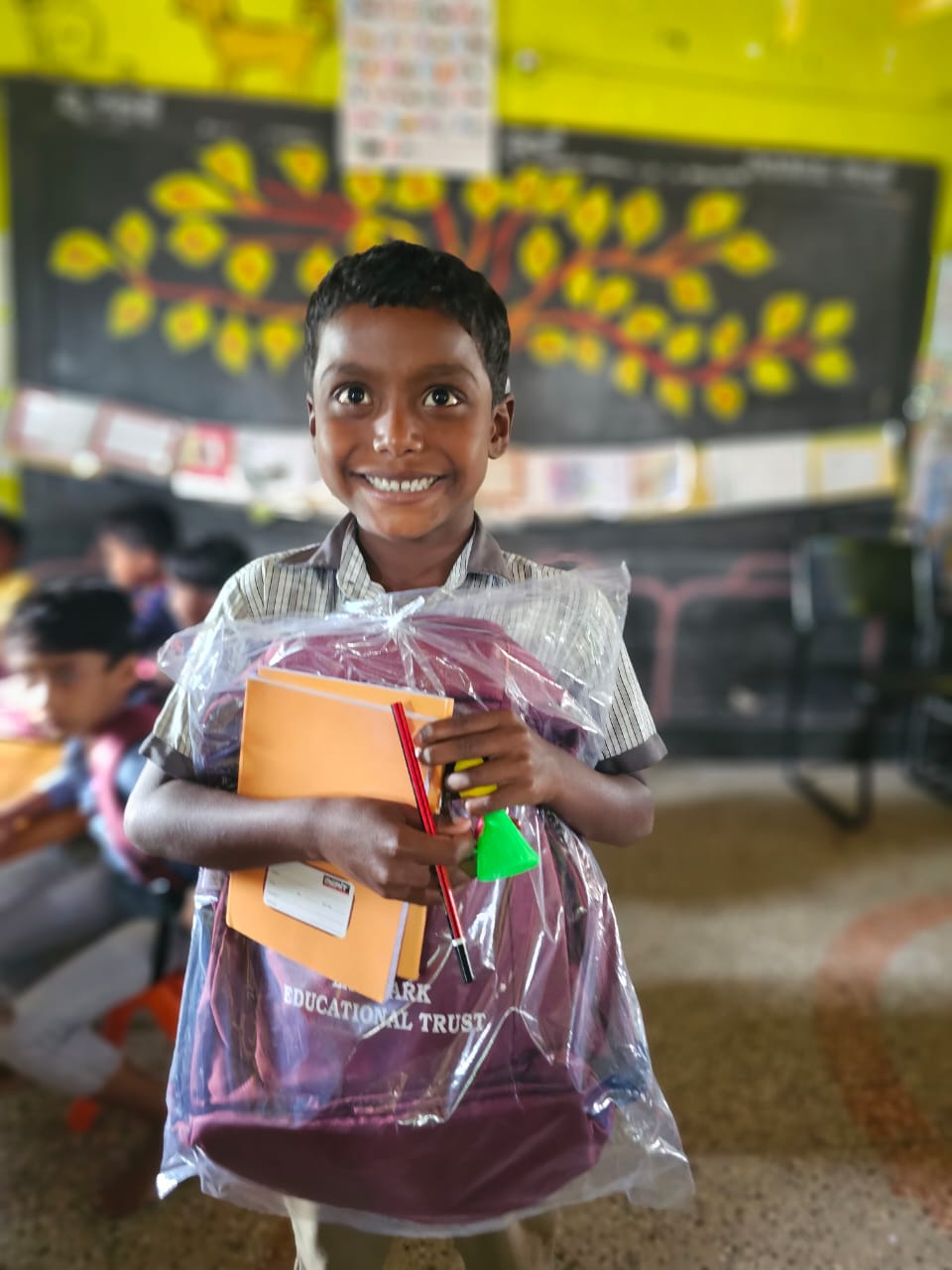 Boy holding school supplies