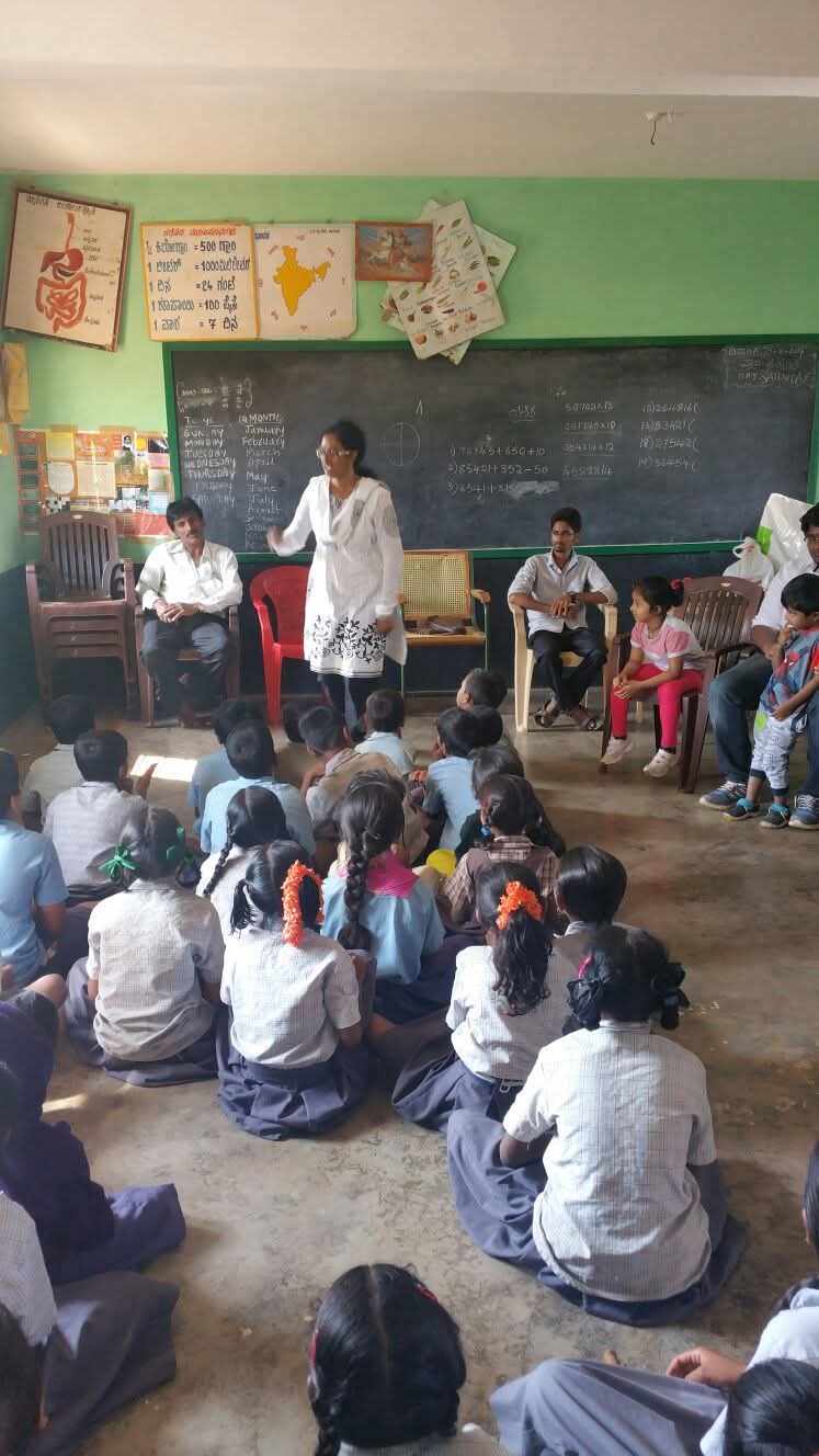 Guest speaker addressing children in a classroom