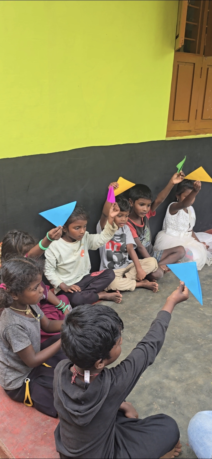 Children holding colorful paper shapes during a craft activity